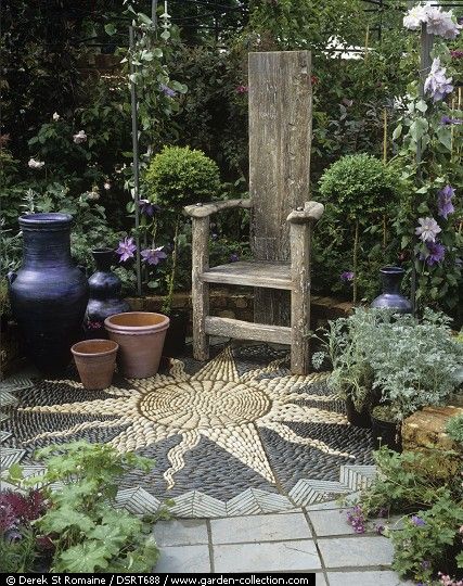 Pots, wooden seat, and floor mosaic made from pebbles and slate