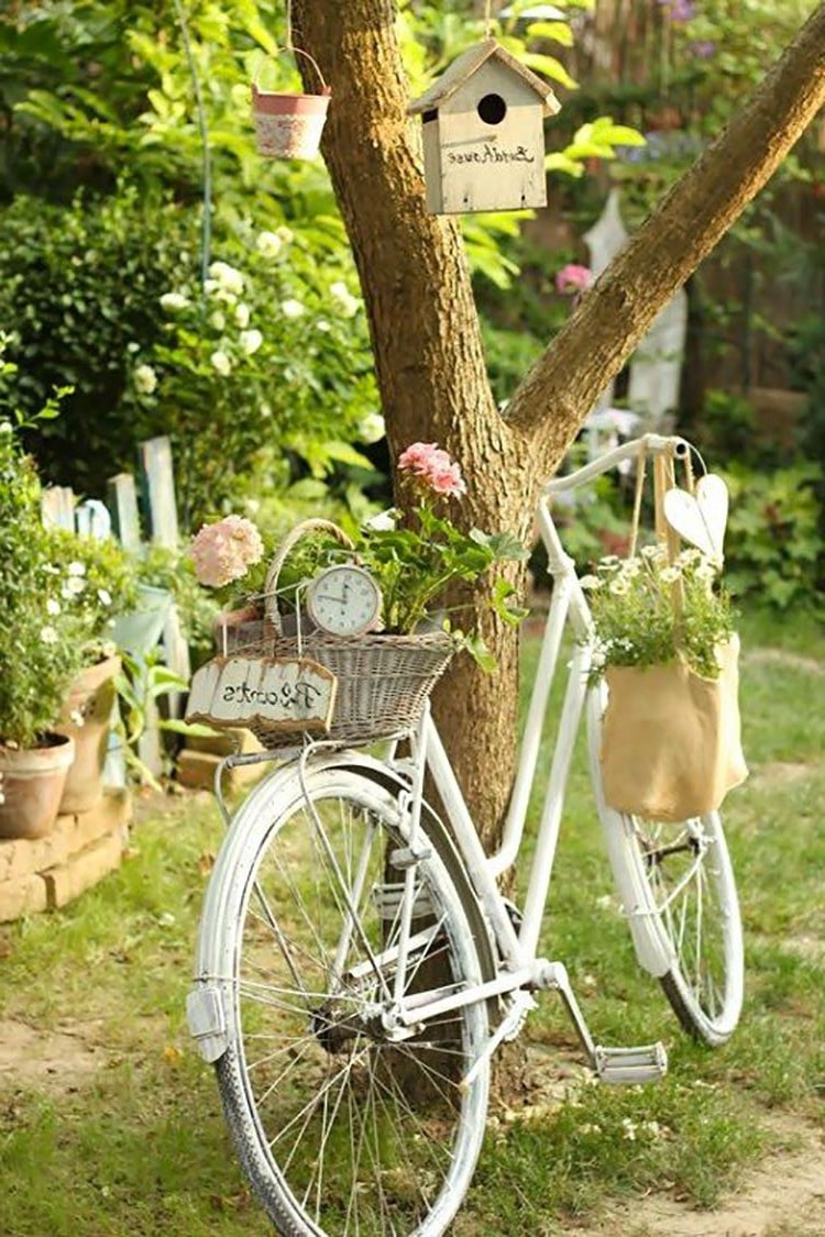 Немного белой краски и старый велосипед обрел новую жизнь в виде элемента декора для сада